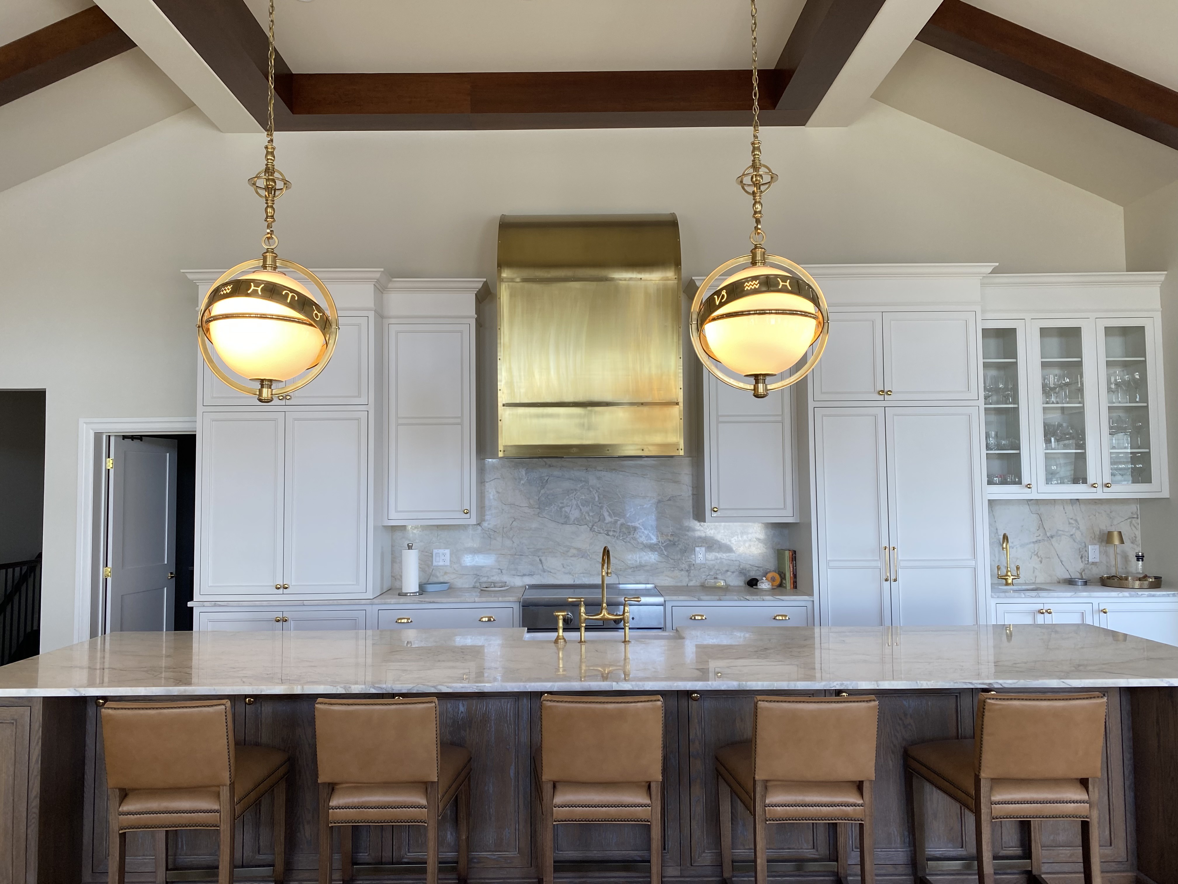 Glen Haven custom white painted kitchen cabinetry with brass hood and shaker doors by Hempston Home