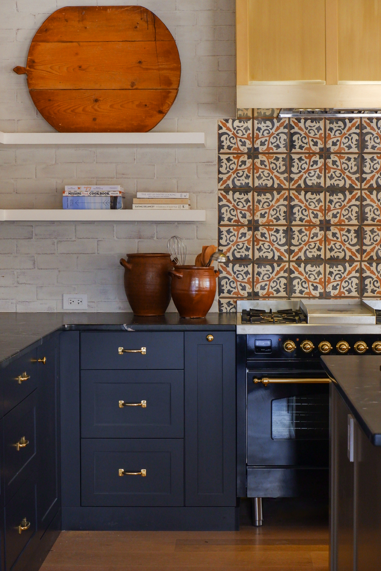 Navy custom cabinetry with brass pulls